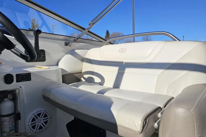 Slide: The Image of Interior of a 2000 Cobalt 293 boat with white seating and steering wheel. - 107