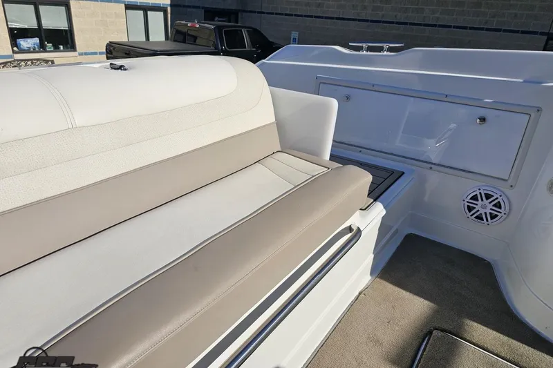 Slide: The Image of Interior of a 2000 Cobalt 293 boat with beige seating and speaker. - 109