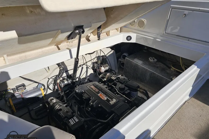 Slide: The Image of Engine compartment of a 2000 Cobalt 293 boat, showcasing mechanical components and wiring. - 111