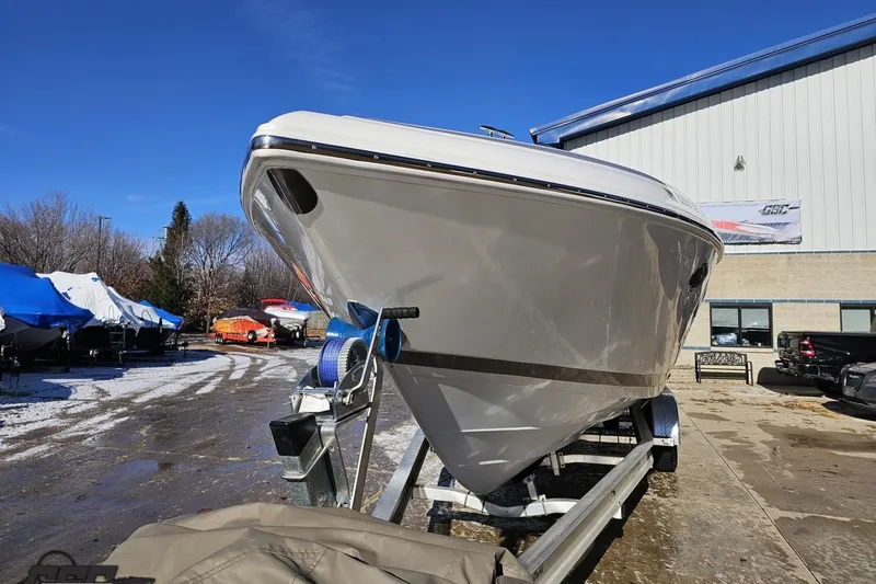 Slide: The Image of 2000 Cobalt 293 boat on trailer, parked outdoors near a building. - 14