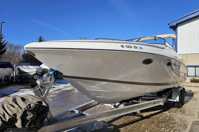 Slide: The Image of 2000 Cobalt 293 boat on trailer, parked outdoors under clear blue sky. - 15