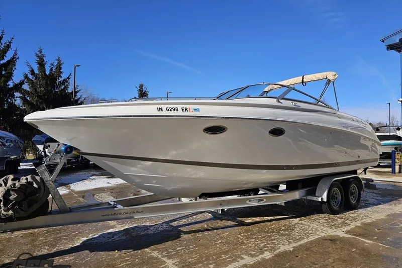 Slide: The Image of 2000 Cobalt 293 boat on trailer under clear blue sky. - 16