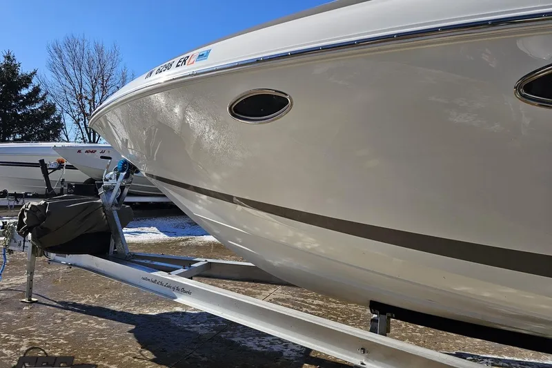 Slide: The Image of 2000 Cobalt 293 boat on trailer, parked outdoors on a sunny day. - 18