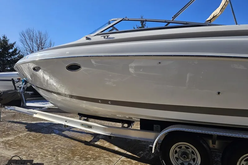 Slide: The Image of 2000 Cobalt 293 boat on trailer under clear blue sky. - 20