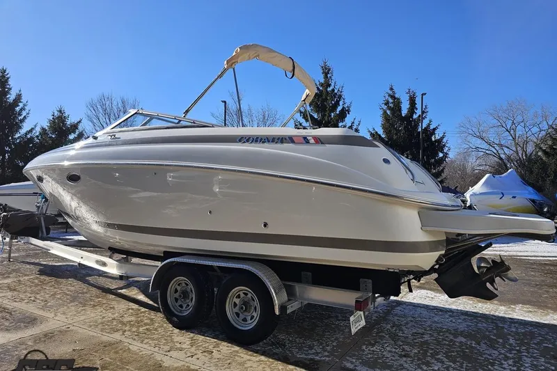 Slide: The Image of 2000 Cobalt 293 boat on trailer, parked outdoors on a sunny day. - 22