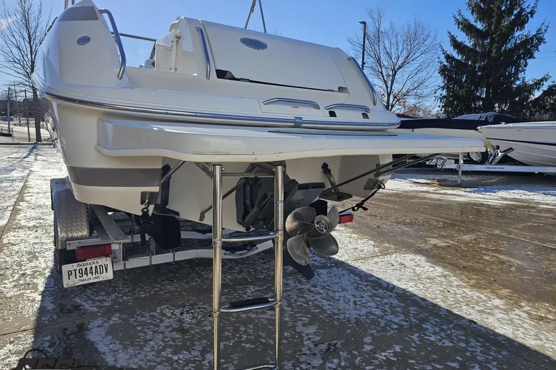 Slide: The Image of 2000 Cobalt 293 boat on trailer, rear view with propeller and ladder. - 29