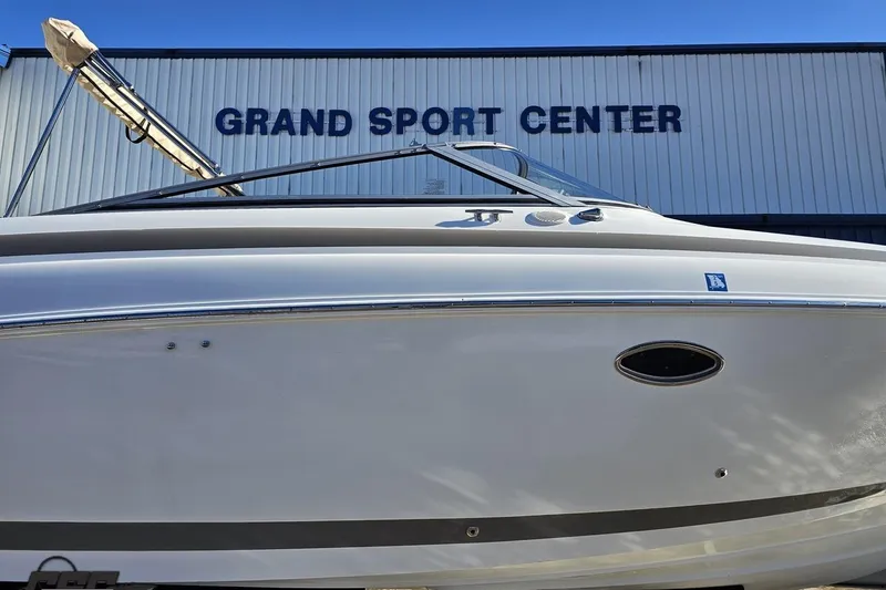 Slide: The Image of 2000 Cobalt 293 boat at Grand Sport Center, side view under clear blue sky. - 3