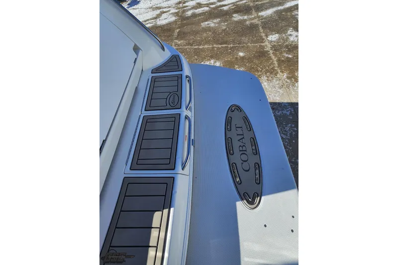 Slide: The Image of 2000 Cobalt 293 boat deck with logo, featuring sleek design and textured surface. - 30