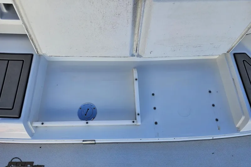 Slide: The Image of Cobalt 293 boat waste compartment, 2000 model, featuring a clean, white storage area. - 34