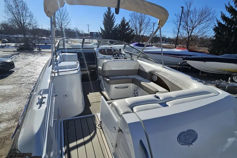Slide: The Image of 2000 Cobalt 293 boat interior with seating and steering wheel, parked outdoors. - 39