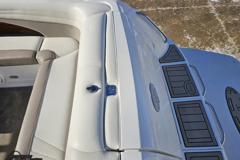 Slide: The Image of Interior view of a 2000 Cobalt 293 boat, featuring white and beige seating. - 40