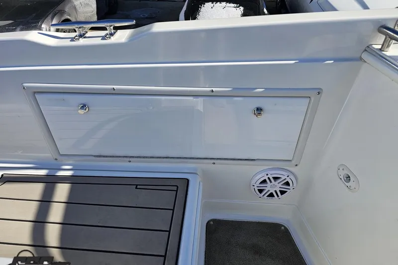 Slide: The Image of Interior of 2000 Cobalt 293 boat showing storage compartment and speaker. - 48