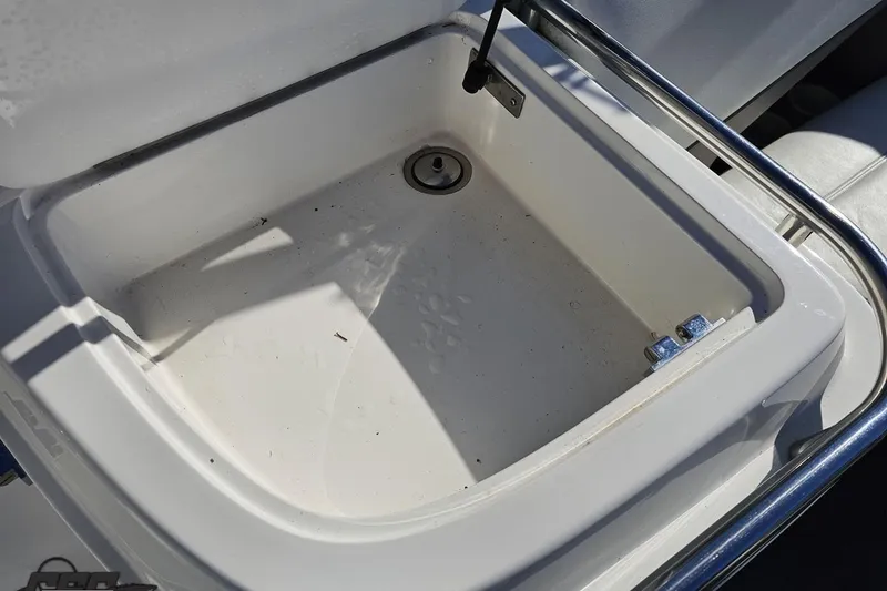 Slide: The Image of Open storage compartment on 2000 Cobalt 293 boat, featuring a clean, white interior. - 52