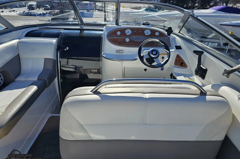 Slide: The Image of Interior of a 2000 Cobalt 293 boat with steering wheel and seating. - 58
