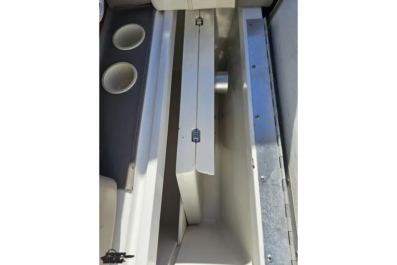 Slide: The Image of Interior view of a 2000 Cobalt 293 boat, featuring cup holders and storage compartment. - 62