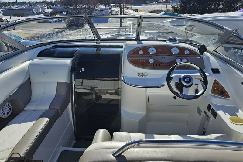 Slide: The Image of Interior of a 2000 Cobalt 293 boat, featuring a sleek dashboard and comfortable seating. - 65