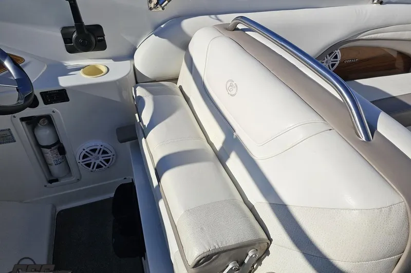 Slide: The Image of Interior of a 2000 Cobalt 293 boat with white seating and stainless steel accents. - 71