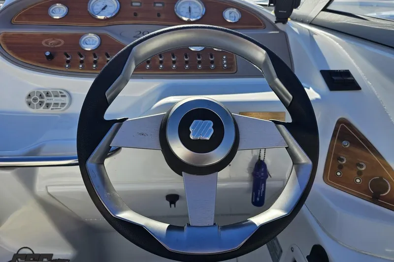 Slide: The Image of Steering wheel of a 2000 Cobalt 293 boat with dashboard controls and gauges. - 75