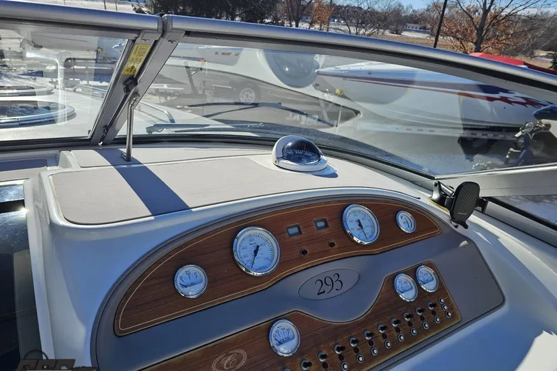 Slide: The Image of Dashboard of a 2000 Cobalt 293 boat with gauges and controls. - 77