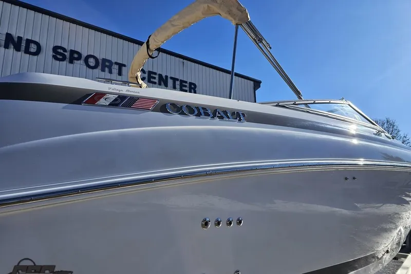 Slide: The Image of 2000 Cobalt 293 boat at a sport center, showcasing sleek design and branding. - 8