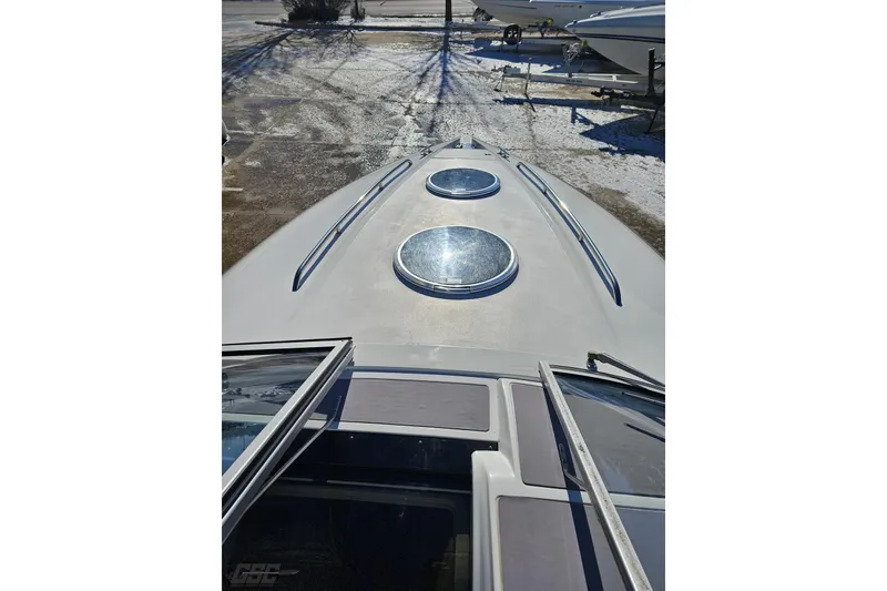 Slide: The Image of 2000 Cobalt 293 boat deck with two circular hatches, parked on snowy ground. - 80