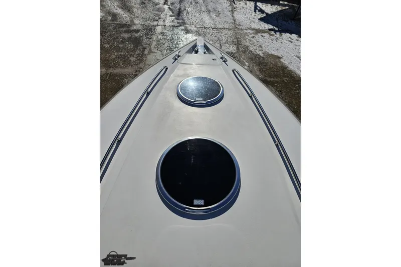 Slide: The Image of Bow view of 2000 Cobalt 293 boat with circular hatches and sleek design. - 81