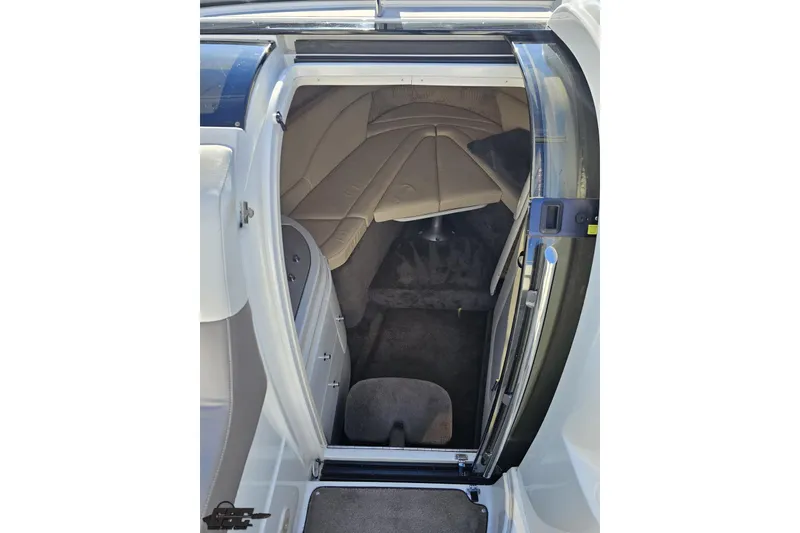 Slide: The Image of Interior cabin of a 2000 Cobalt 293 boat, featuring beige upholstery and carpet. - 84