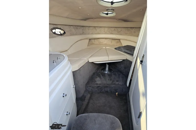 Slide: The Image of Interior cabin of a 2000 Cobalt 293 boat with beige seating and carpet. - 85