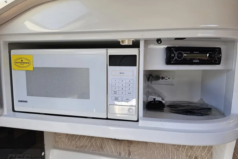 Slide: The Image of Microwave and stereo system in 2000 Cobalt 293 boat interior. - 89