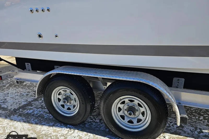 Slide: The Image of Trailer with dual wheels supporting a 2000 Cobalt 293 boat on a snowy surface. - 9