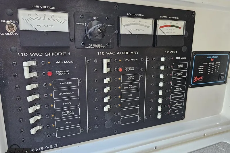 Slide: The Image of Electrical control panel of a 2000 Cobalt 293 boat with various switches and meters. - 91