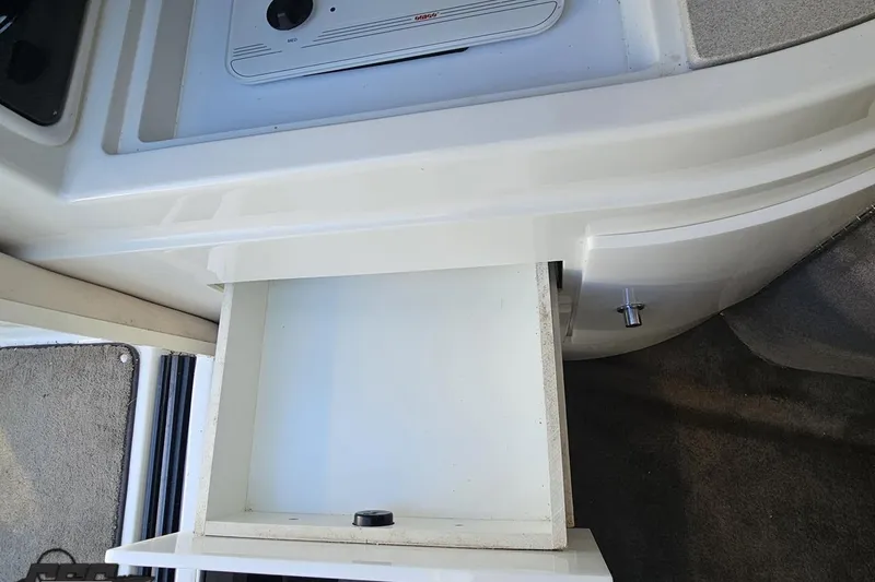 Slide: The Image of Open drawer in 2000 Cobalt 293 boat interior, showing storage space. - 93