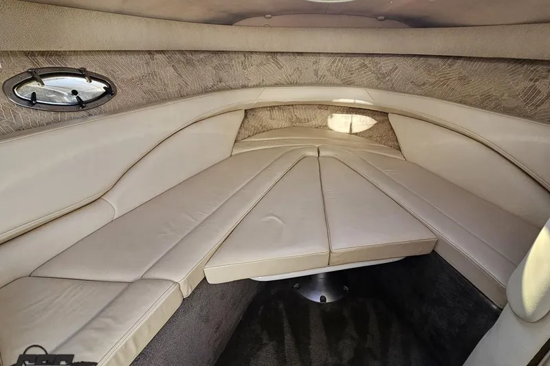 Slide: The Image of Interior cabin of a 2000 Cobalt 293 boat with beige upholstery and porthole window. - 96
