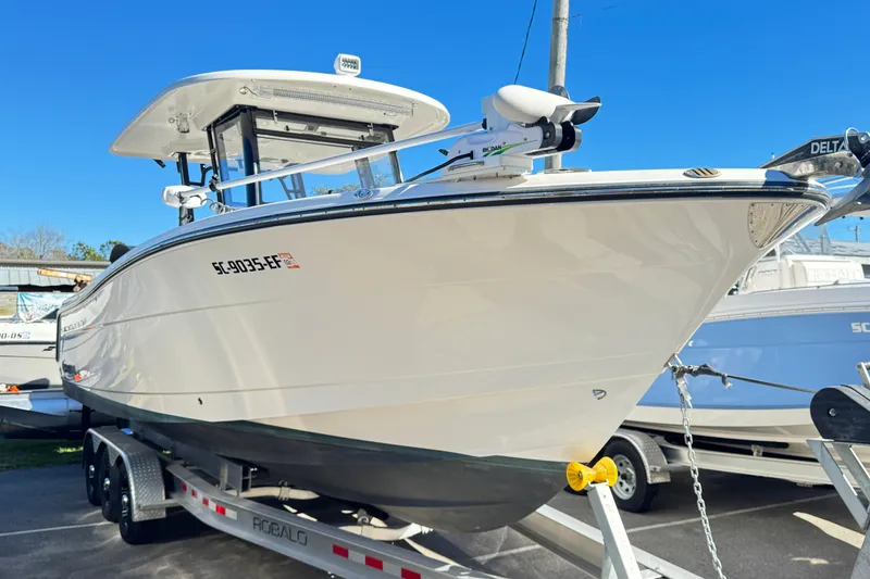 The Image of 2023 Robalo R302 Center Console boat on trailer, displayed outdoors. - 0