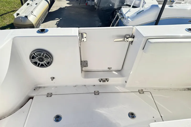 Slide: The Image of 2023 Robalo R302 Center Console boat interior with speaker and storage hatch. - 10