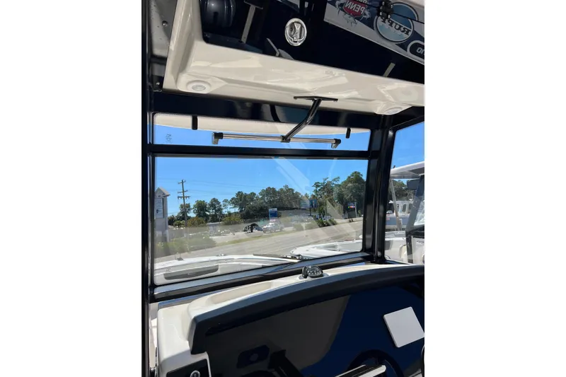 Slide: The Image of 2023 Robalo R302 Center Console boat interior with clear windshield view. - 20