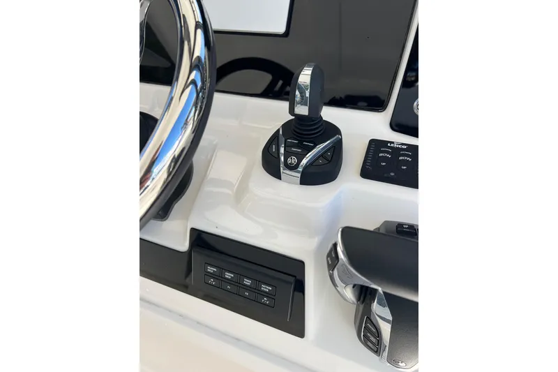 Slide: The Image of 2023 Robalo R302 Center Console helm with joystick and control panel. - 21
