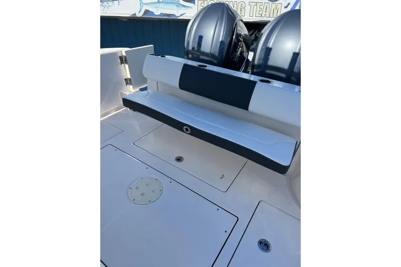 Slide: The Image of 2023 Robalo R302 Center Console boat with dual engines and seating area. - 24