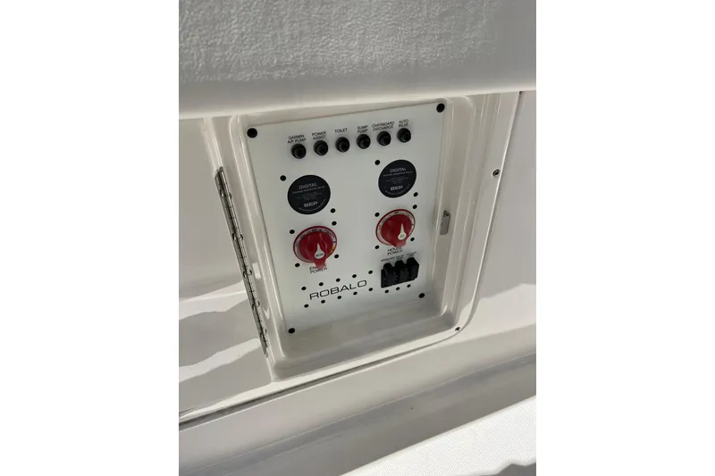 Slide: The Image of Control panel of 2023 Robalo R302 Center Console boat with switches and dials. - 25