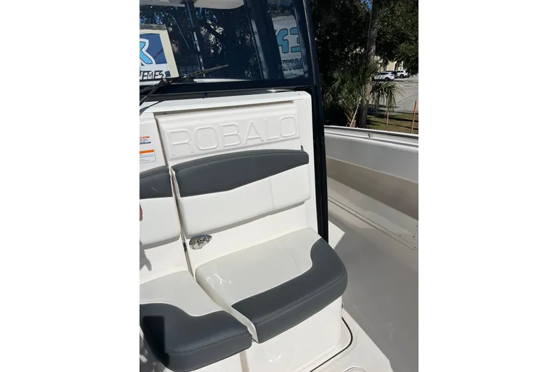 Slide: The Image of 2023 Robalo R302 Center Console boat seat with logo, outdoor setting. - 26