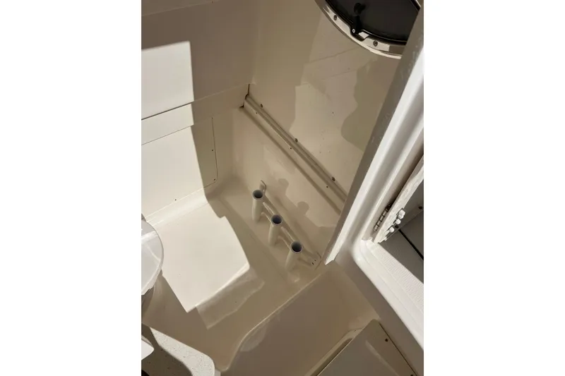 Slide: The Image of 2023 Robalo R302 Center Console interior detail with rod holders. - 27