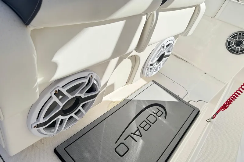 Slide: The Image of 2023 Robalo R302 Center Console boat interior with speakers and branded mat. - 5