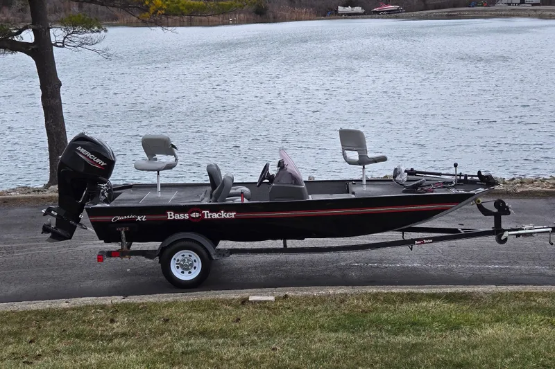 The Image of 2021 Tracker Bass Tracker Classic XL boat by a lake on a trailer. - 0