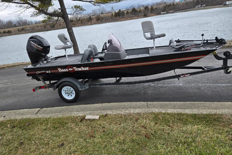 Slide: The Image of 2021 Tracker Bass Tracker Classic XL boat on trailer by a lake. - 10