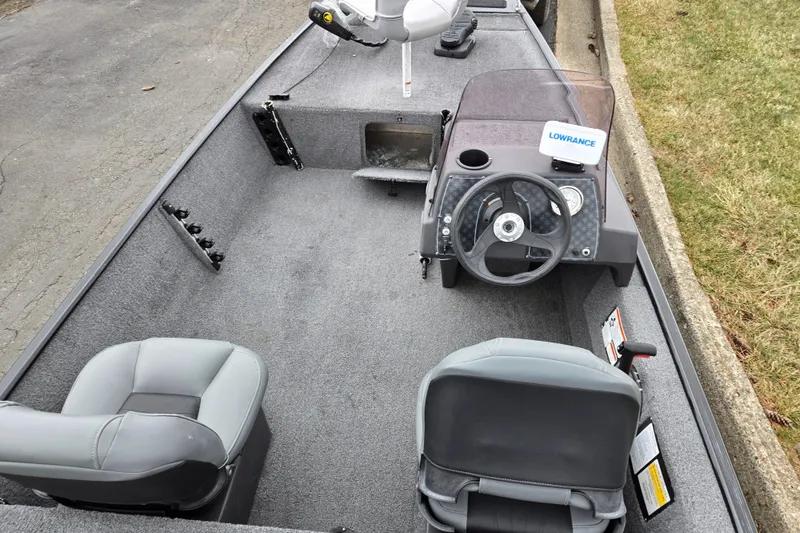 Slide: The Image of 2021 Tracker Bass Tracker Classic XL boat interior with steering wheel and seating. - 11