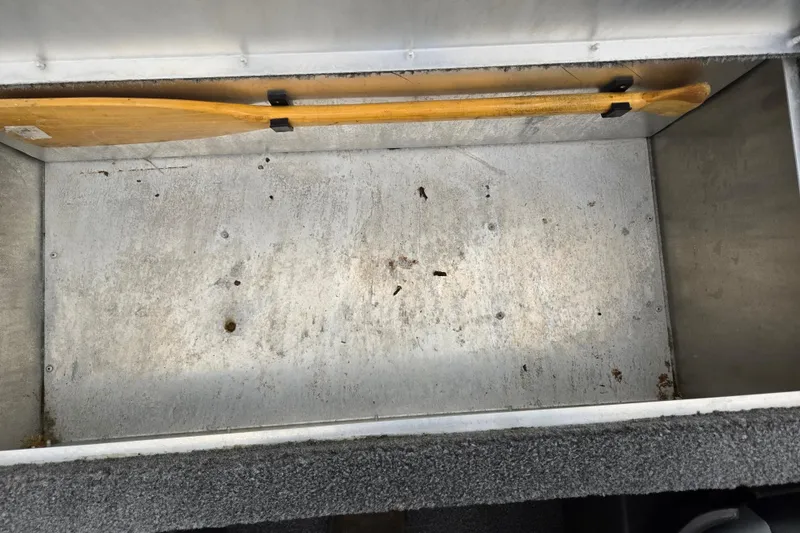 Slide: The Image of Storage compartment of 2021 Tracker Bass Tracker Classic XL with wooden paddle inside. - 22