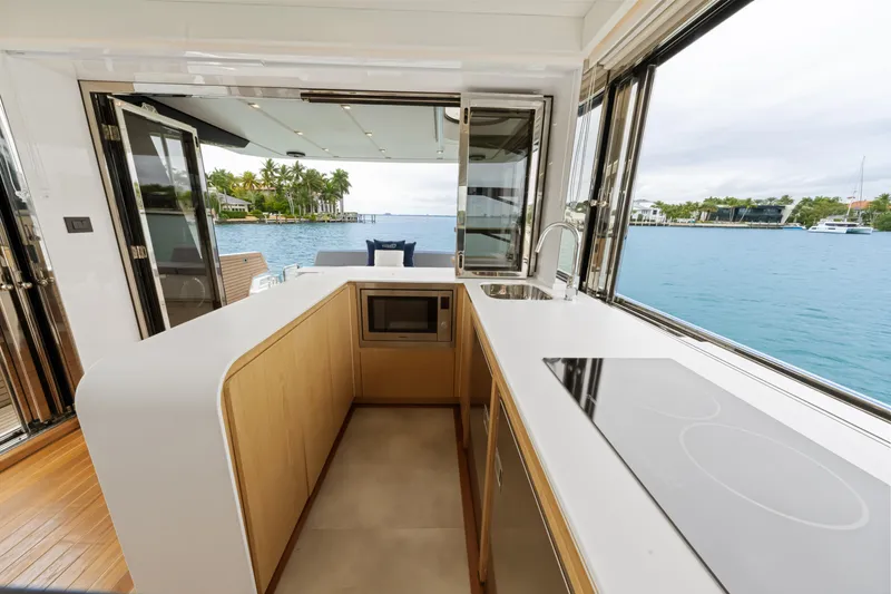 Slide: The Image of The modern kitchen on the OKEAN 52 offers a view of the water through large windows. - 38