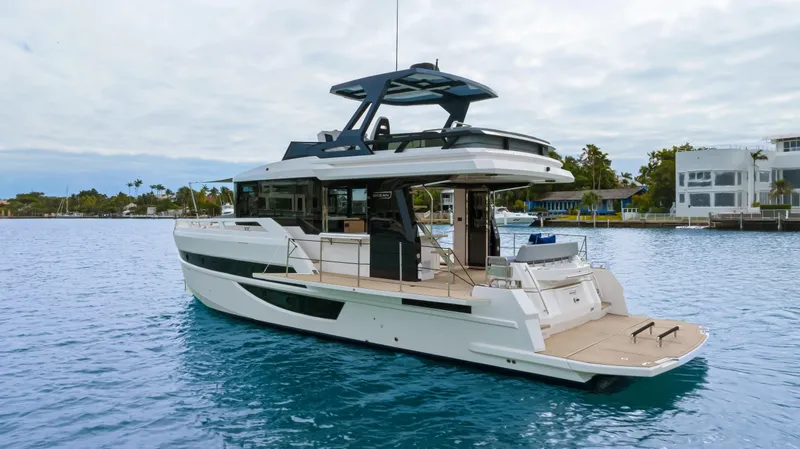 Slide: The Image of The 2026 OKEAN 52 is a modern motor yacht with an open deck and sleek design. - 28