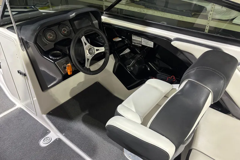 Slide: The Image of 2016 Yamaha Boats 242 Limited S cockpit with steering wheel and dashboard controls. - 12
