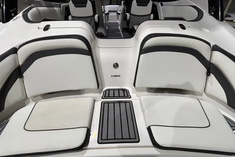 Slide: The Image of 2016 Yamaha Boats 242 Limited S interior seating with sleek white and black design. - 15